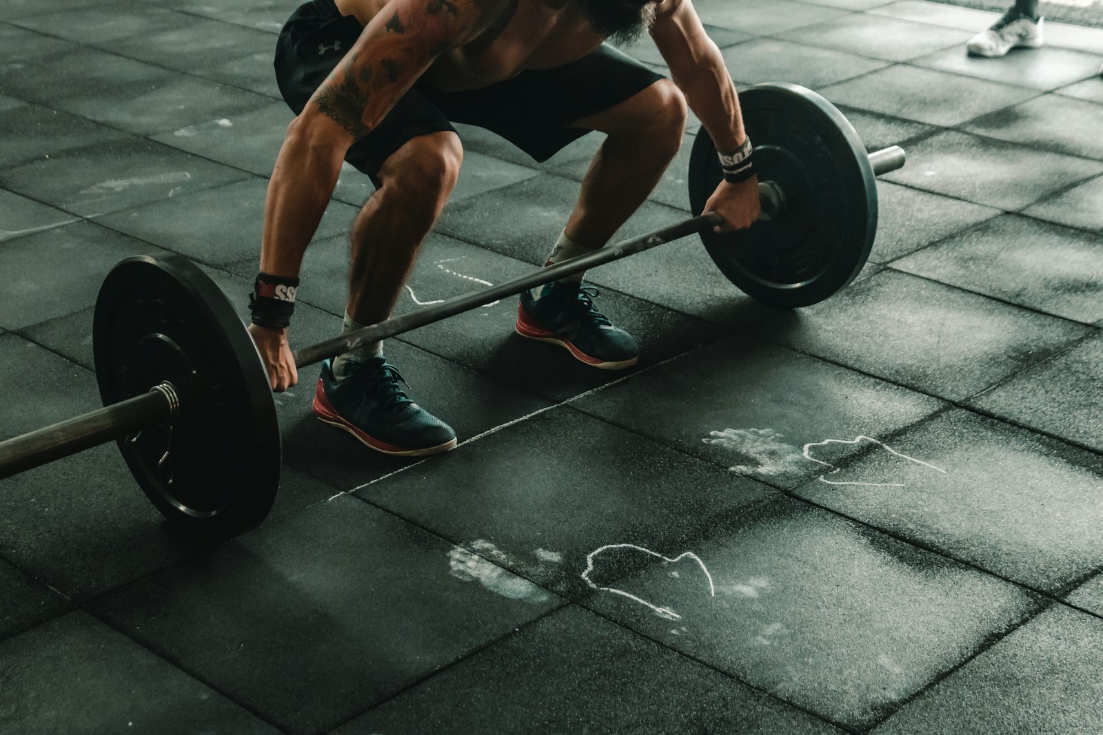 A person lifting a dumbbell in a gym